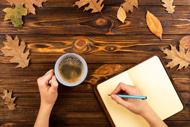 A close-up shot of a person's hands filling out the FAFSA form on a laptop, with a cup of coffee and a pen nearby. The focus is on the form and the intent to fill it out accurately.