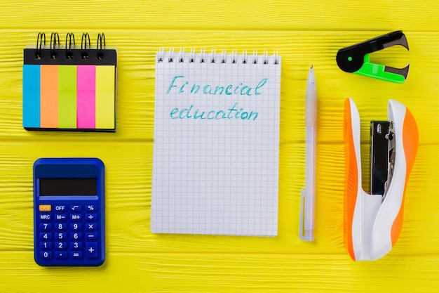 A close-up shot of a student's hands highlighting key figures of a financial aid award letter with a bright yellow marker, emphasizing tuition fees, grant amounts, and loan options.