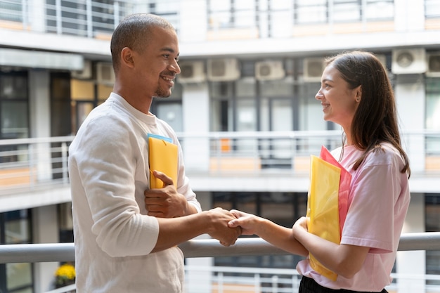 A student enthusiastically shaking hands with a recruiter at a college career fair; the setting emphasizes the importance of networking and making connections in securing internship opportunities.