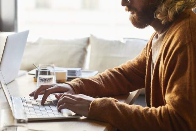 An individual working on a laptop, focused on filling out an online form with the title 