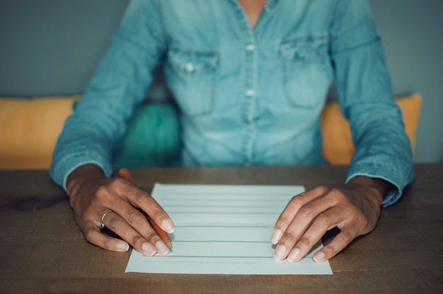 An image showing a close-up of a hand filling out a grant application form, with a laptop displaying the official government grants website in the background. Focus on the details of the paperwork and the digital interface.
