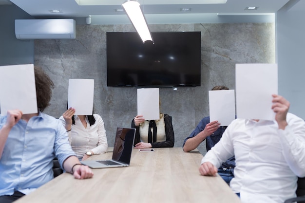A photograph of a diverse panel of grant reviewers discussing and evaluating application documents in a conference room setting, emphasizing the seriousness and thoroughness of the review process.