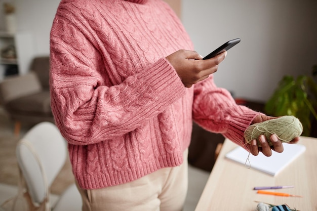 A person using a budgeting app on their smartphone, showcasing the importance of tracking expenses to meet spending requirements and maximize credit card rewards.