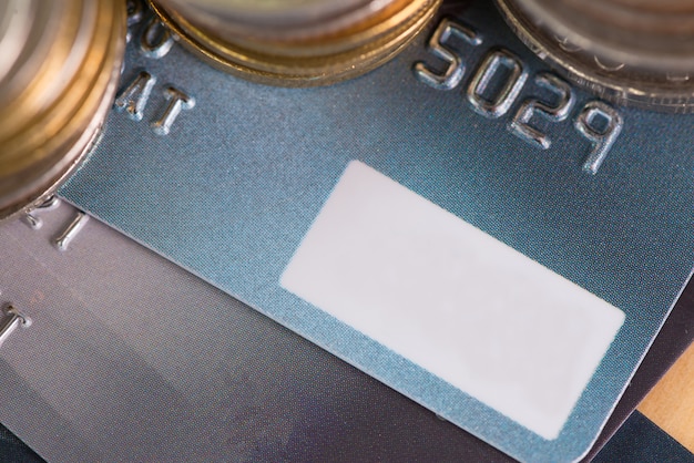 A close-up of a HSA debit card with money in the background, visually representing tax benefits for health savings account contributions.