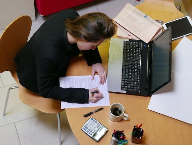 A person sitting at a desk, working on a laptop, with paperwork and a calculator nearby, symbolizing the process of managing student loans and exploring forgiveness options.